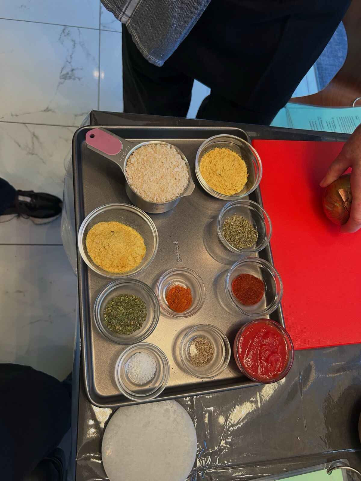 A tray of measured spices and grains ready before cooking